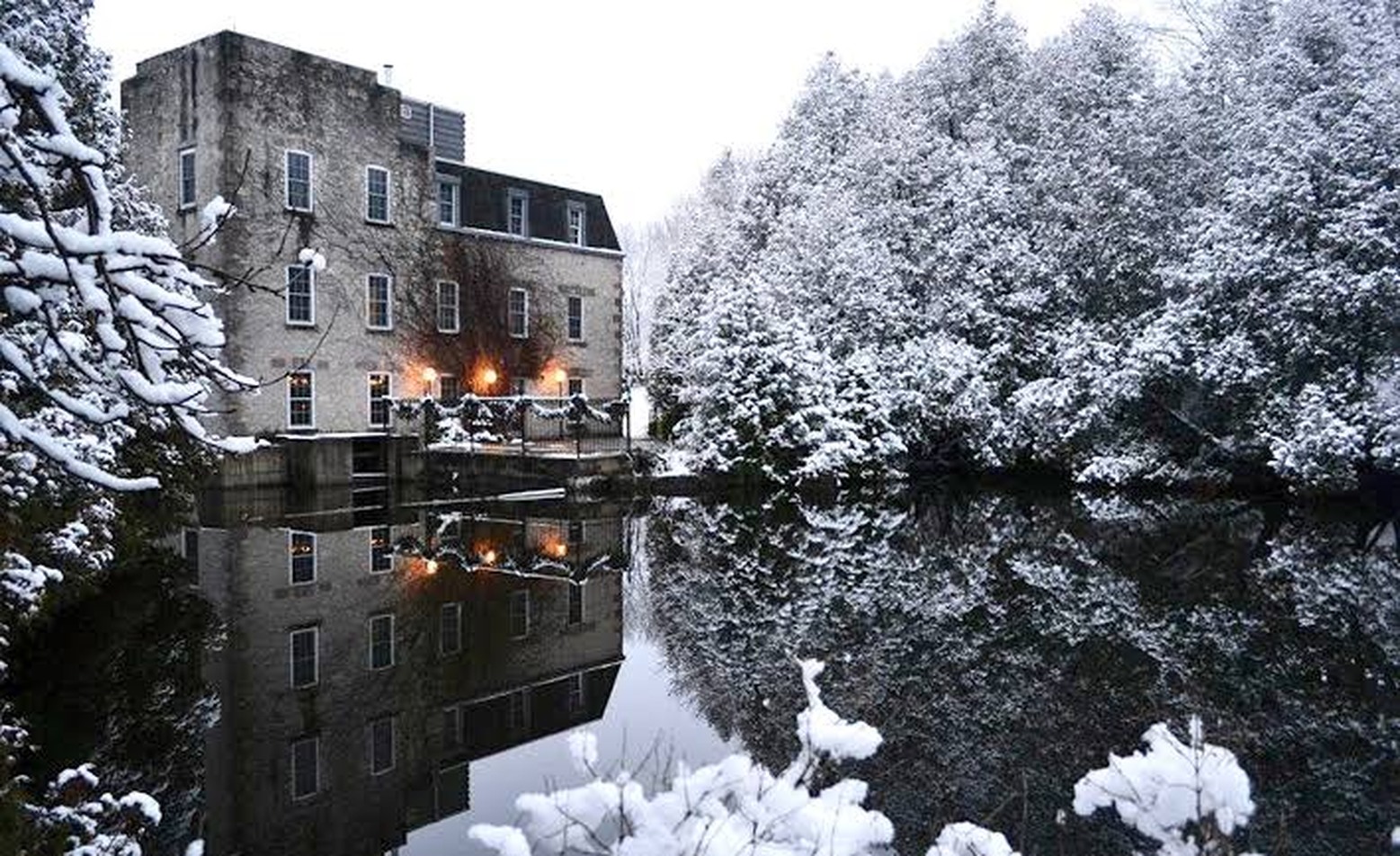 Millcroft Inn reflected in the river after snowfall